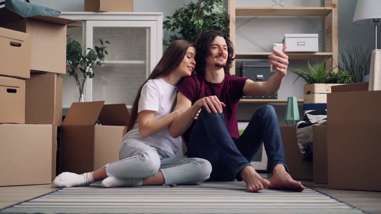 Happy Couple Taking a Selfie in Their New Home