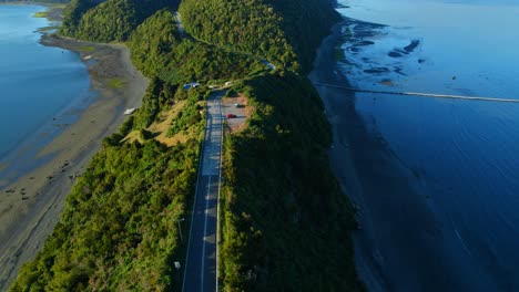 Aerial-shot-of-Lemuy-Island's-Detif-channel-with-lush-greenery-and-a-boat,-serene-and-secluded