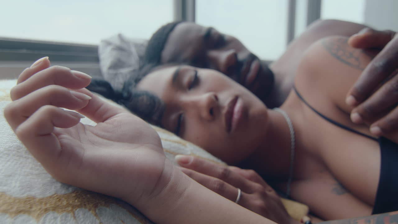 Young Woman Sleeping with Boyfriend in Bed