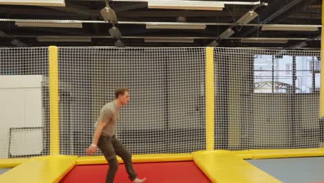 man performing parkour and acrobatics in a trampoline park