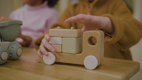 little boy playing with wooden blocks