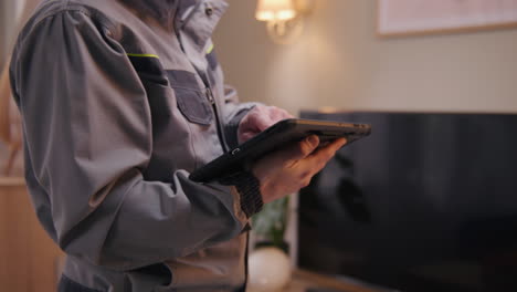 technician inspecting home system with tablet