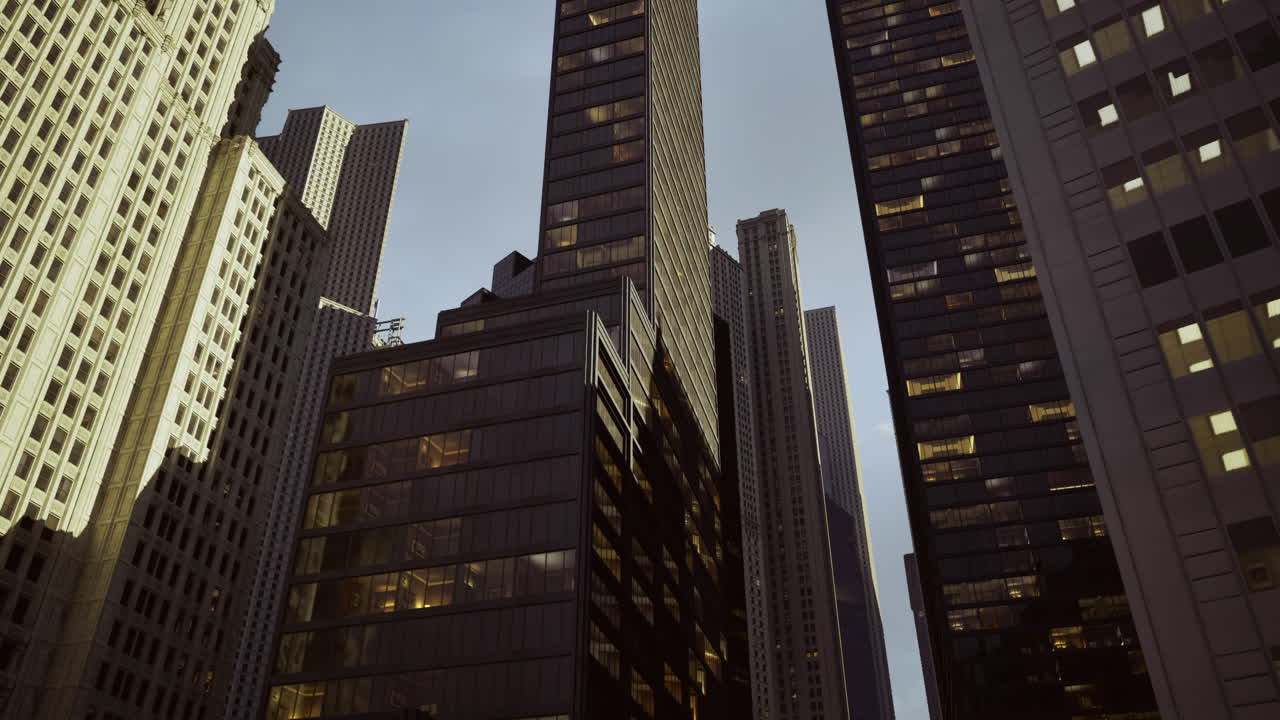 Modern skyscrapers reach toward the sky in an urban landscape at sunset