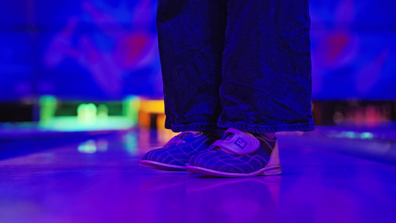 Slow Motion Cinematic Shot Of Woman Jumping In Bowling Hall With RGB Colors
