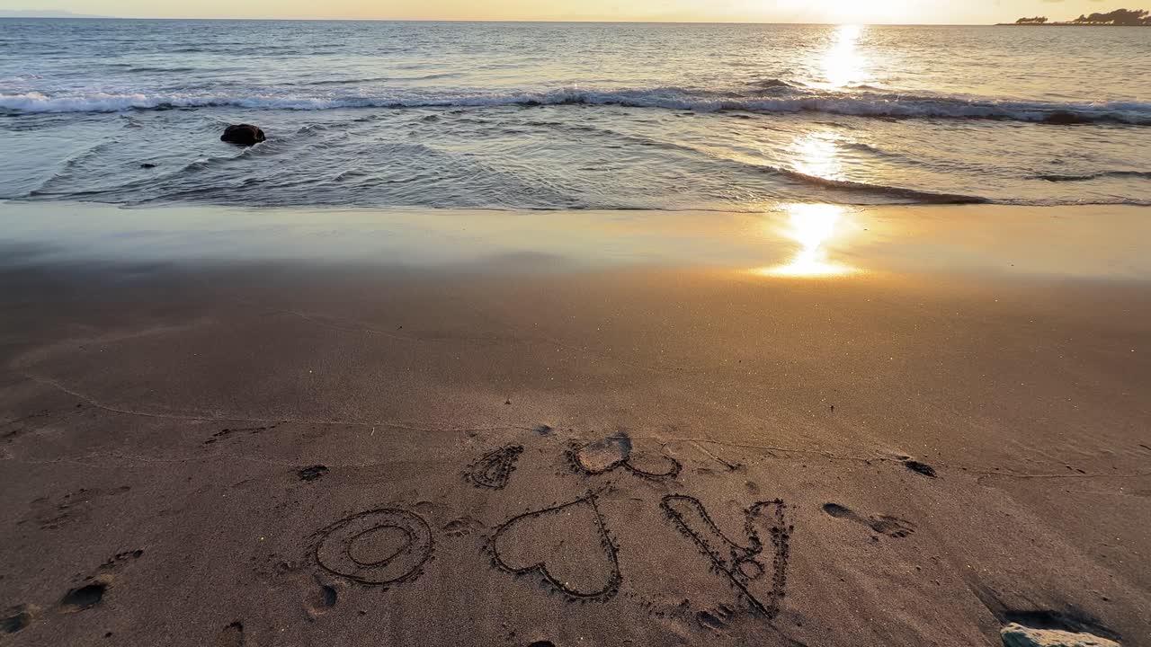 Romantic Sunset on Beach with Love Message Written in Sand
