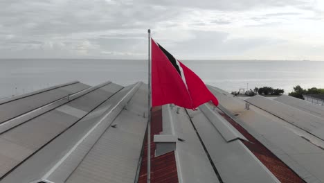 trinidad and tobago national flag in the wind using a drone