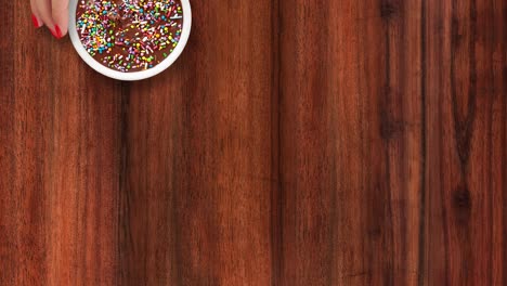 offering chocolate dessert with multi colored sprinkles