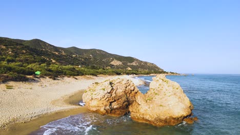 aerial drone clip backward from a rock formation in kavala, macedonia, greece