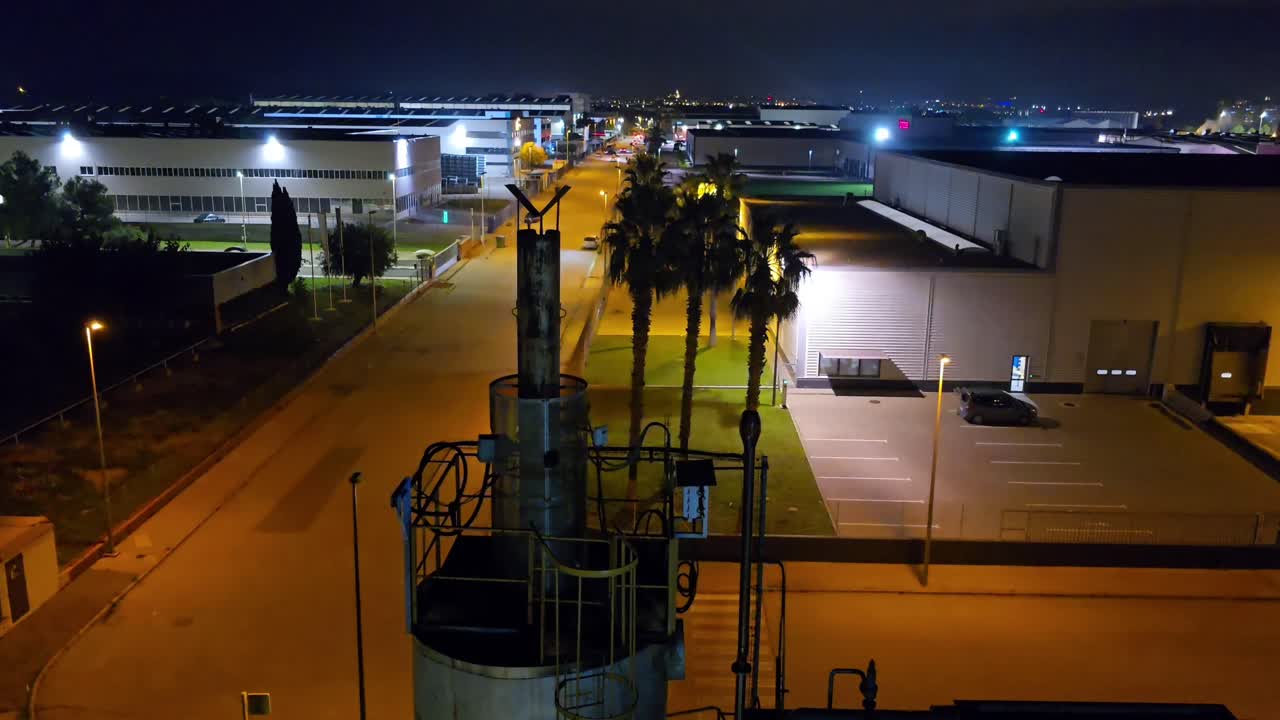 Departure of the vehicles of the workers of the Chemical Factory, general plan partial view of the factory, you can see the closed and starry night.