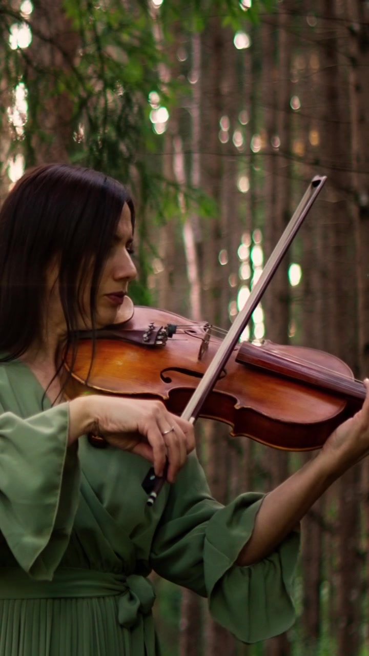 Woman Playing Violin in a Serene Forest Setting
