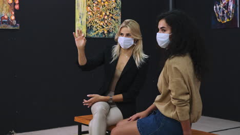 women viewing abstract art at an exhibition