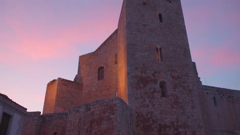 Low-angle-shot-of-Peniscola-castle,-residence-of-the-Antipope-Benedict-XIII-in-Peniscola,-Castellon,-Spain-during-evening-time