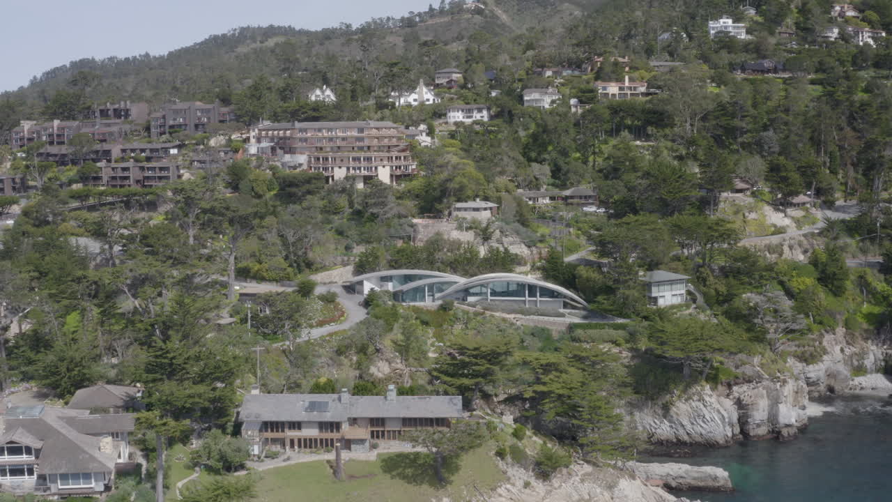 4K aerial over cliff side mansions in the Carmel Highlands California.