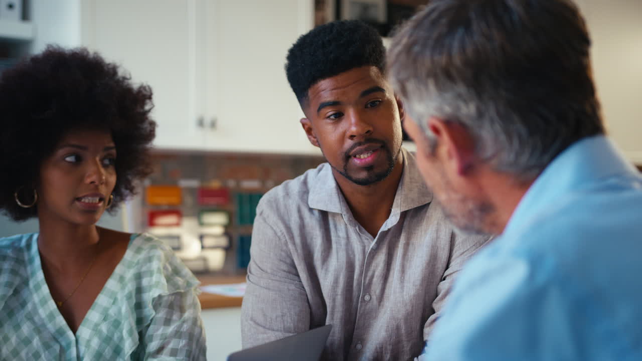 Male And Female Business Team With Laptop Meeting In Modern Office