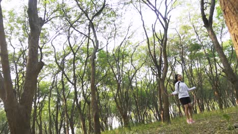 Athletic-Beautiful-Woman-Exercises-with-Jump,-Skipping-Rope-in-the-forest