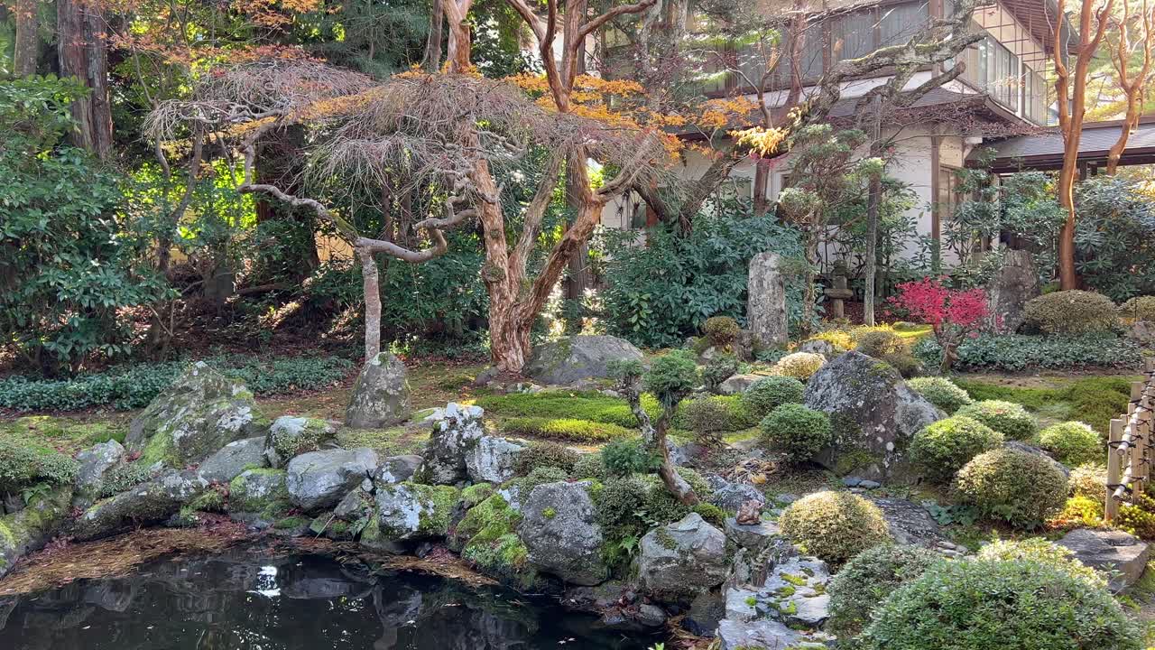 Beautiful pond with house and autumn colors in Japan