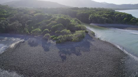 Couple-Walks-On-Pebbles-On-The-Coral-Sea-Coast-Near-The-Mouth-Of-Emmagen-Creek-In-Cape-Tribulation,-Queensland