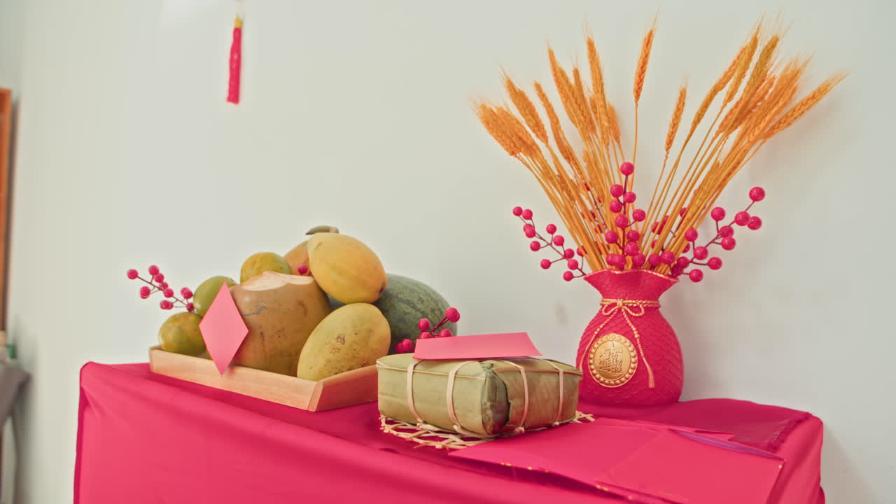 Fresh Fruits, Red Envelopes and Vase on Table Decorated for Tet Celebration