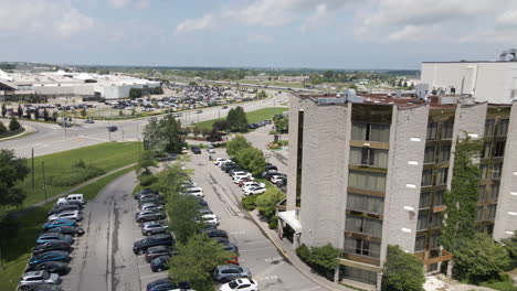 drone orbit around fancy luxury condo apartments as sun glistens and reflects