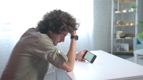 focus on phone, young man disappointed for failed strategy of trading