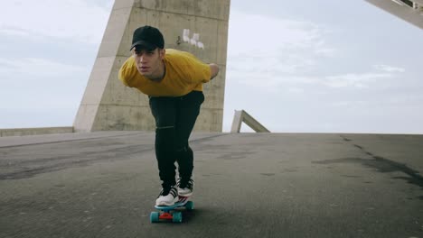 epic portrait and close upt of a young attractive trendy man skateboarding fast under a solar panel on a morning sunny day with an urban city background in slow motion