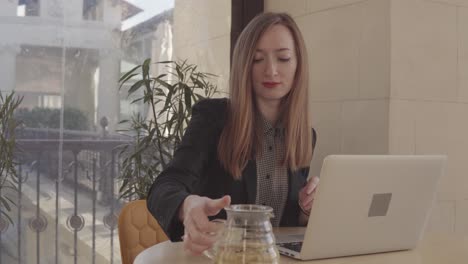 woman working on a laptop in a cafe