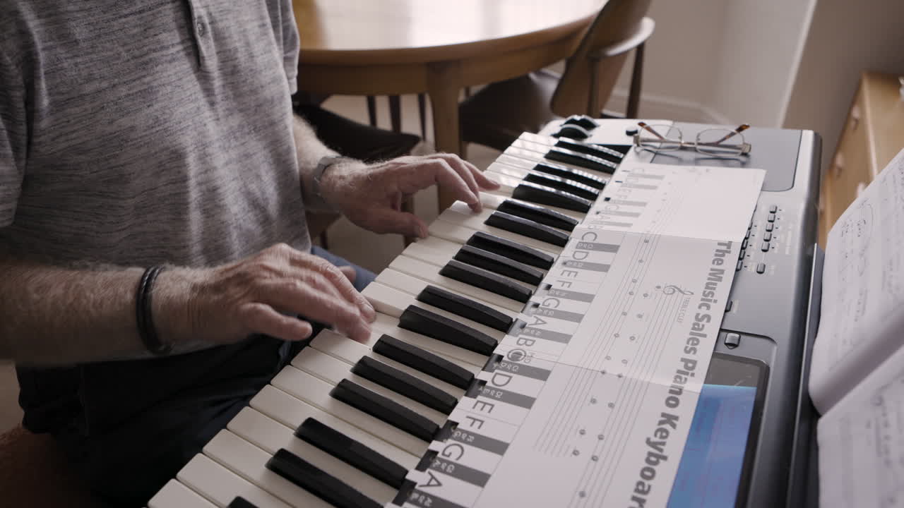 An elderly man playing the piano