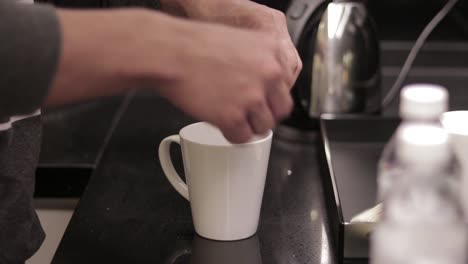 man preparing a cup of tea