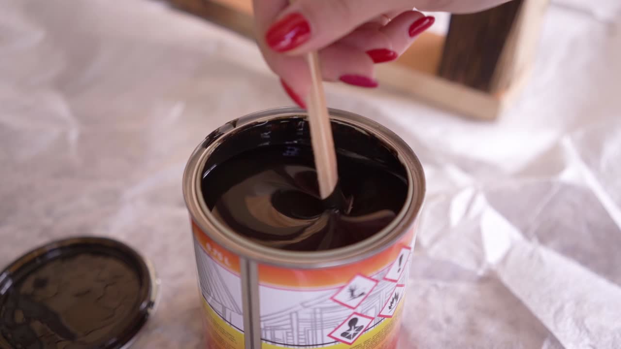 Mixing wood paint, brown paint slow motion 100fps
