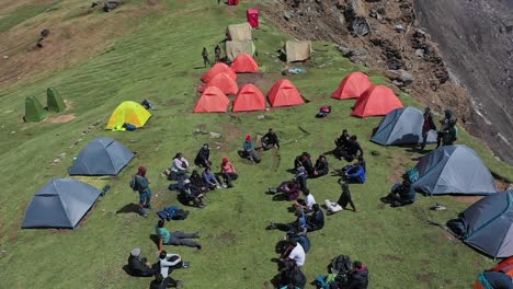 hikers resting in a campsite in the mountains - aerial shot