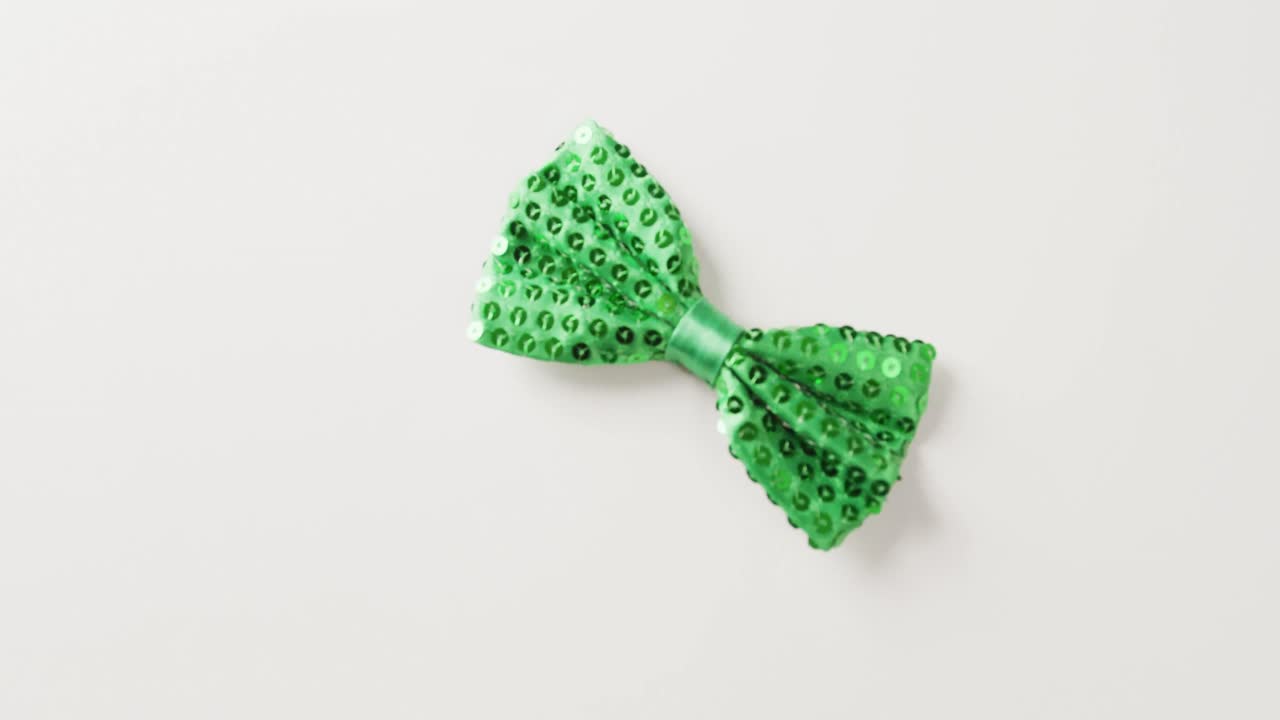 Video of st patrick's green bow tie with copy space on white background