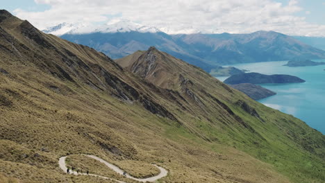 Tourists-hiking-switchback-trail-on-beautiful-mountainside-slope-with-breathtaking-view