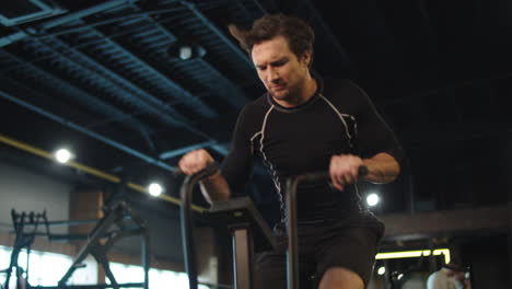 atleta masculino haciendo ejercicio en bicicleta en un club deportivo. hombre de fitness entrenando en el gimnasio