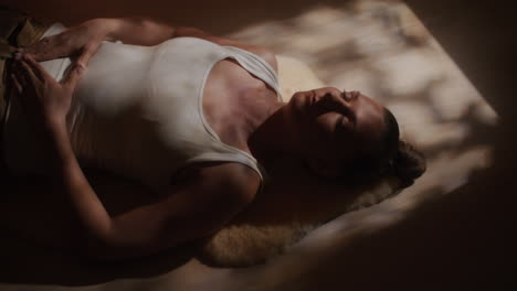 woman relaxing on a sheepskin rug