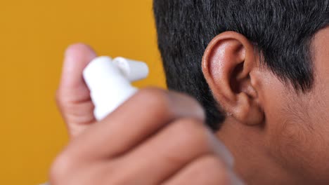 boy applying ear spray