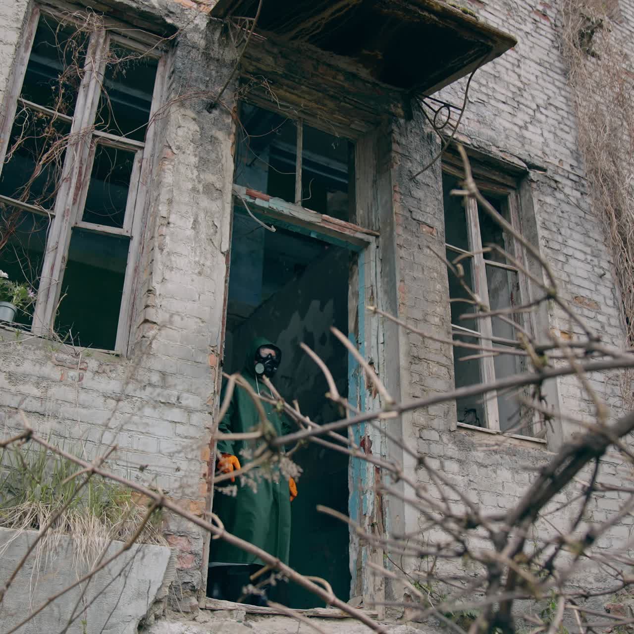 Apocalyptic pollution architecture. Man in special suit going out in abandoned creepy place