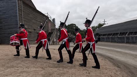 soldiers in red uniforms marching through sovereign hill