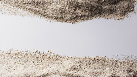 video of close up of sand grains and copy space on white background