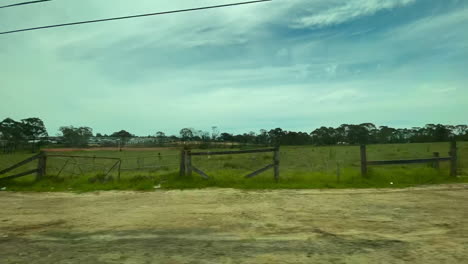 Fast-moving-driving-time-lapse-POV-through-Sydney,-Australia,-suburban-neighbourhood-fields-and-woodland