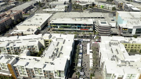 aerial view of a modern mixed-use urban development with an outdoor market