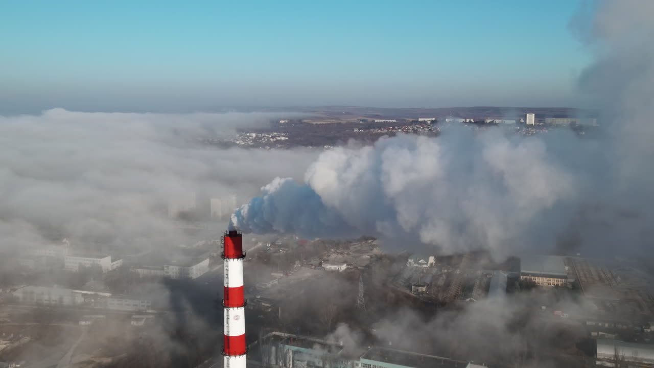 Aerial drone view of industrial smoke coming from pipe factory tube. City pollution idea