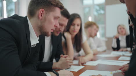 male-and-female-managers-are-viewing-papers-with-charts-and-data-in-business-meeting