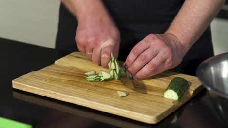 chef chopping cucumber