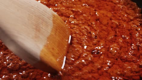 Cooking tomato sauce close-up. Classic homemade Italian tomato sauce for pasta and pizza in the pan. Chef cooking traditional Italian food. High quality 4k footage