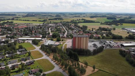 aerial dolly out landscape shot of lantmännen lantbruk agribusiness industrial structure of farm grain silos for agriculture crops storage in rural brålanda town sweden