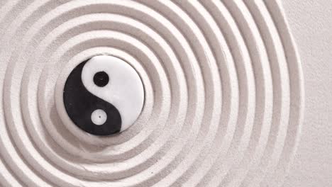 japanese zen garden with yin yang stones in textured sand