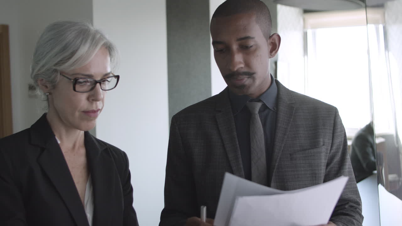 Male broker explaining diagrams to female investor