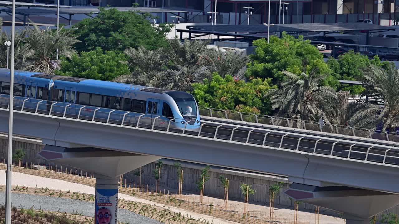 A close-up of a Dubai Metro train as it heads to its next stop along Sheikh Zayed Road in Dubai, UAE.