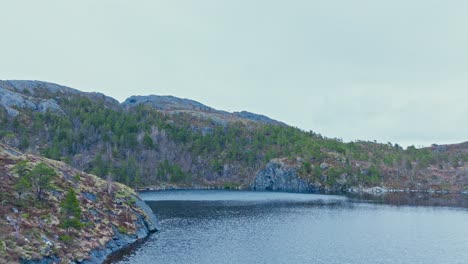 Serene Lake Kattavatnet With Reflections, Surrounded By Rocky Mountains In Roan, Norway. wide drone shot