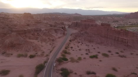 aerial - road between the mountains at dawn, cafayate, argentina, wide shot